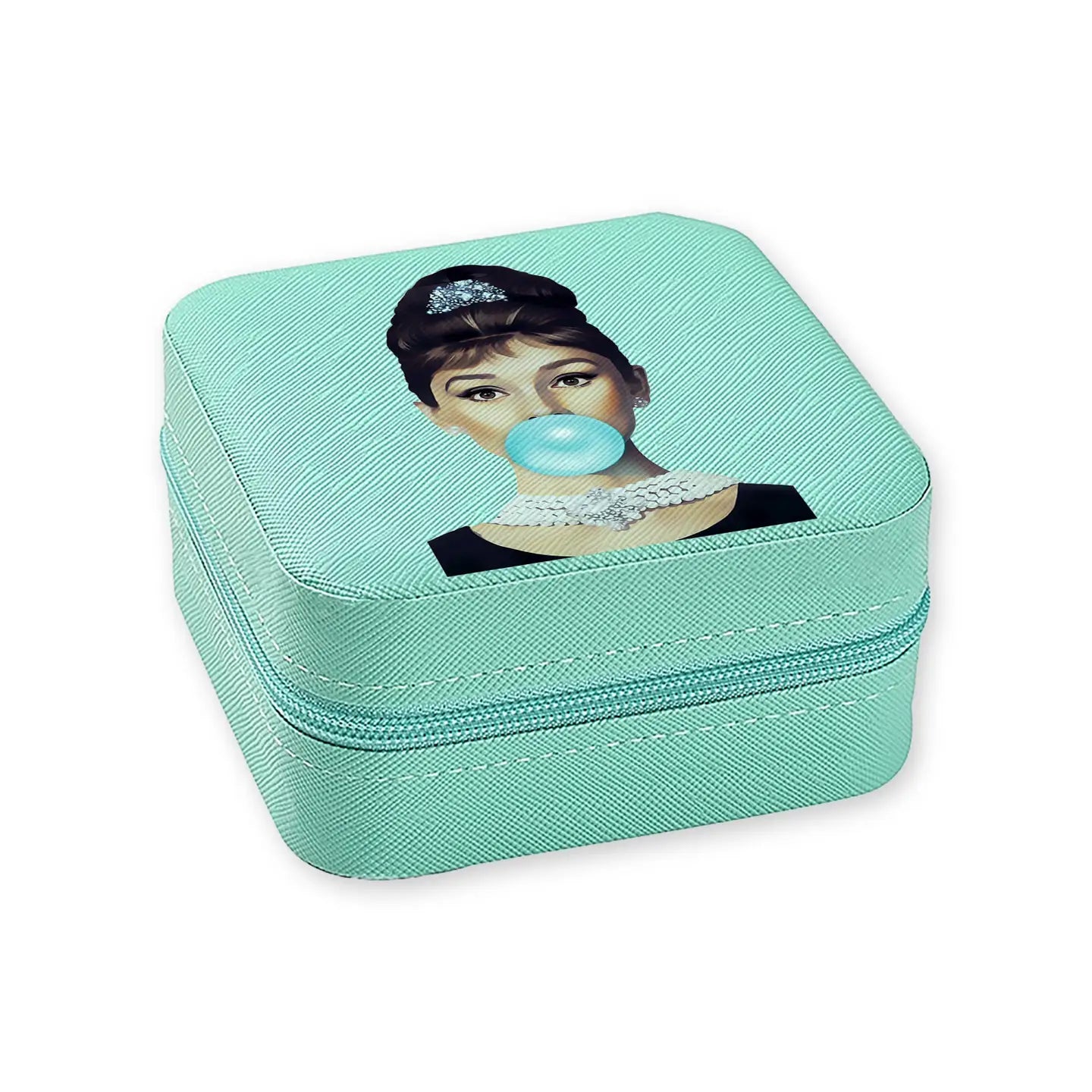A luxurious travel jewelry box inspired by Audrey Hepburn's timeless elegance in Breakfast at Tiffany's, designed to safely store your jewelry with style on the go.