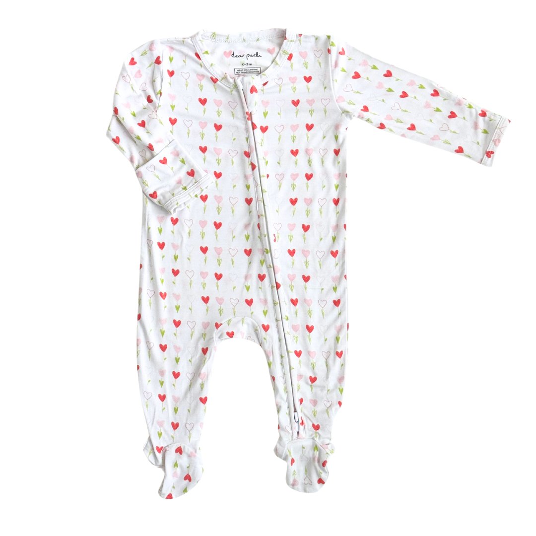 Soft bamboo baby zippered footie onesie with a playful heart print, featuring a full-length zipper for easy dressing and built-in footies for extra warmth and comfort.